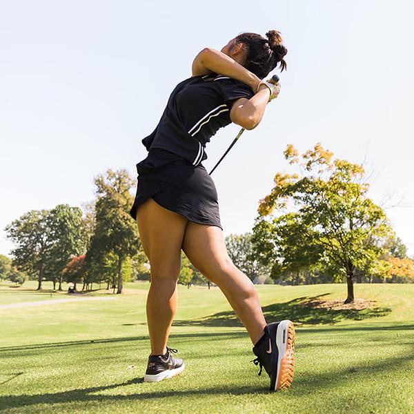 A woman playing golf, women's golf socks